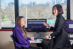Dr. Mina Ahn speaking with a student