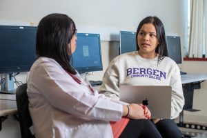 Kaylie Quezada speaking with professor