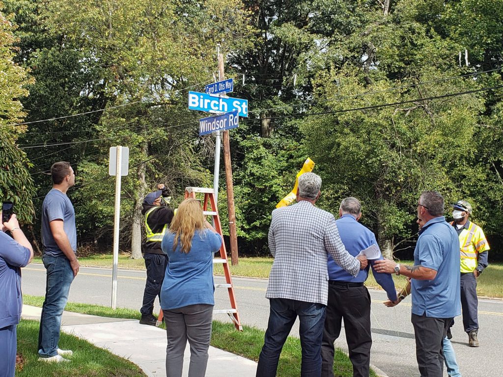 Members of the Otis family watch as “Carol D. Otis Way” becomes a reality in Teaneck.