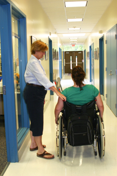 Nurse helping student in wheelchair